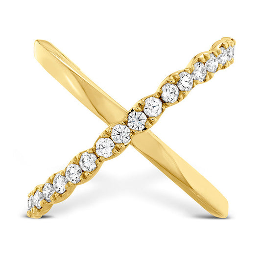 The Hearts On Fire Lorelei 18K Yellow Gold Diamond Criss Cross Fashion Ring features intersecting 18 Karat yellow gold bands, with one band plain and the other adorned with brilliant white diamonds, creating an elegant and modern design that embodies sophistication.