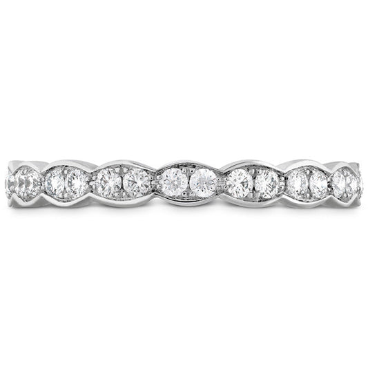 A detailed view of the Hearts On Fire Lorelei Floral 18K White Gold Round Brilliant Diamond Eternity Ring reveals a series of round and marquise-shaped diamonds arranged in an elegant, alternating pattern. The simple white background accentuates the radiance and intricate design of this exquisite wedding band by Hearts on Fire.