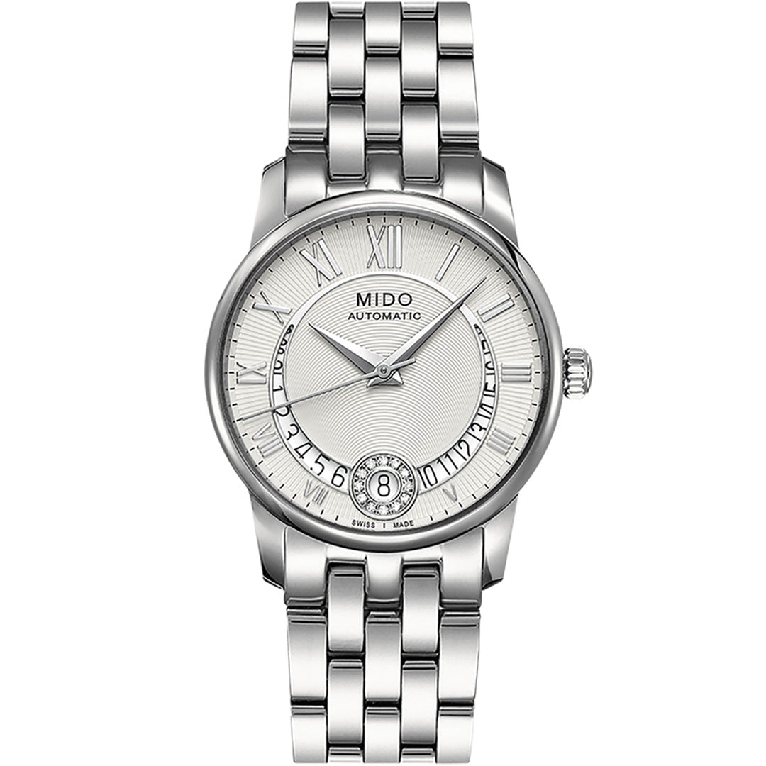 The MIDO Baroncelli II Lady Diamonds Automatic 33mm features a silver metal link band, Roman numerals, a textured white dial, and a date window at 6 o’clock.