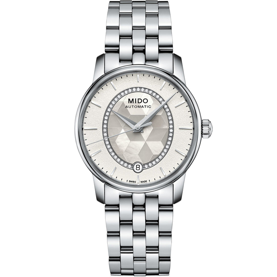 The MIDO Baroncelli II Prisma Automatic 33mm features a silver metallic link band, textured light dial, slim hour markers, and a date display at 6 o’clock.