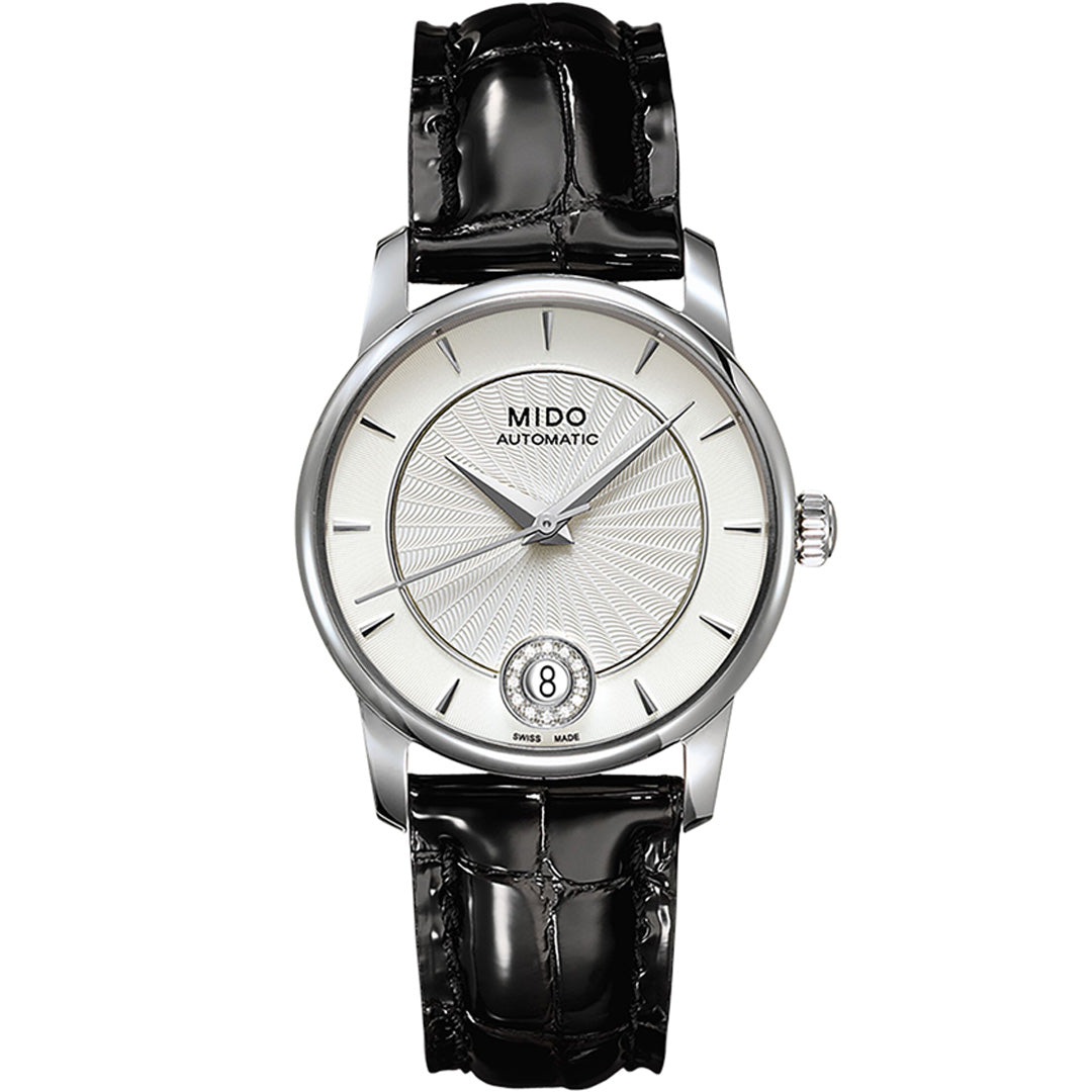The MIDO Baroncelli II Lady Diamonds Automatic 33mm Watch features a textured white dial, slim silver markers, date at 6 o’clock, automatic movement, and a glossy black leather strap.