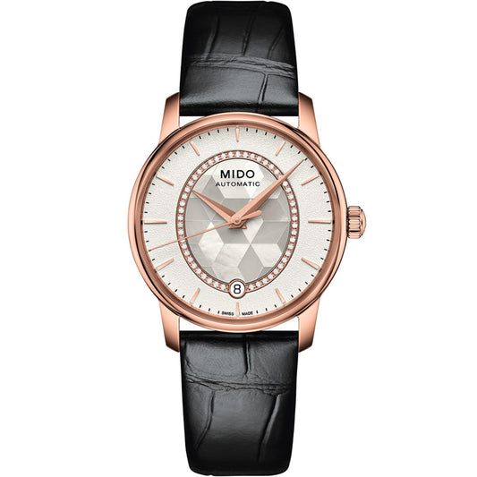 The MIDO Baroncelli II Prisma Automatic 33mm Watch features a rose gold case, white textured dial with gold hour markers, date display at 6 o’clock, and a black leather strap.