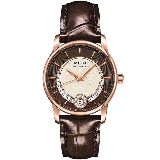 The MIDO Baroncelli II Lady Diamonds Automatic 33mm Watch features a brown leather strap, gold-tone case, round dial with gold hour markers, date at 6 o’clock, and “Mido Automatic” branding for a refined look.