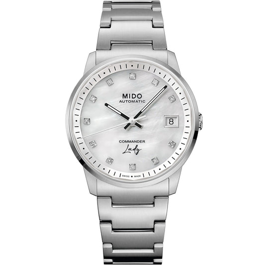 The MIDO Commander Lady Automatic 35mm Watch for women features a silver metal bracelet, white mother-of-pearl dial with diamond hour markers, date window at 3 o’clock, and displays "MIDO AUTOMATIC" & "COMMANDER Lady" on the face.