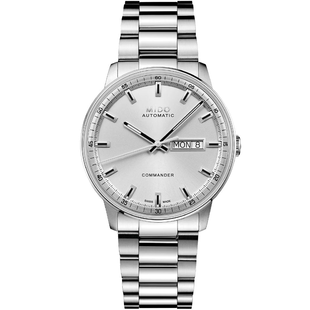 The MIDO Commander Datoday Automatic 40mm Watch features a stainless steel case and band, silver dial with baton hour markers, and a day-date display at 3 o’clock showing “Mon 8.”.