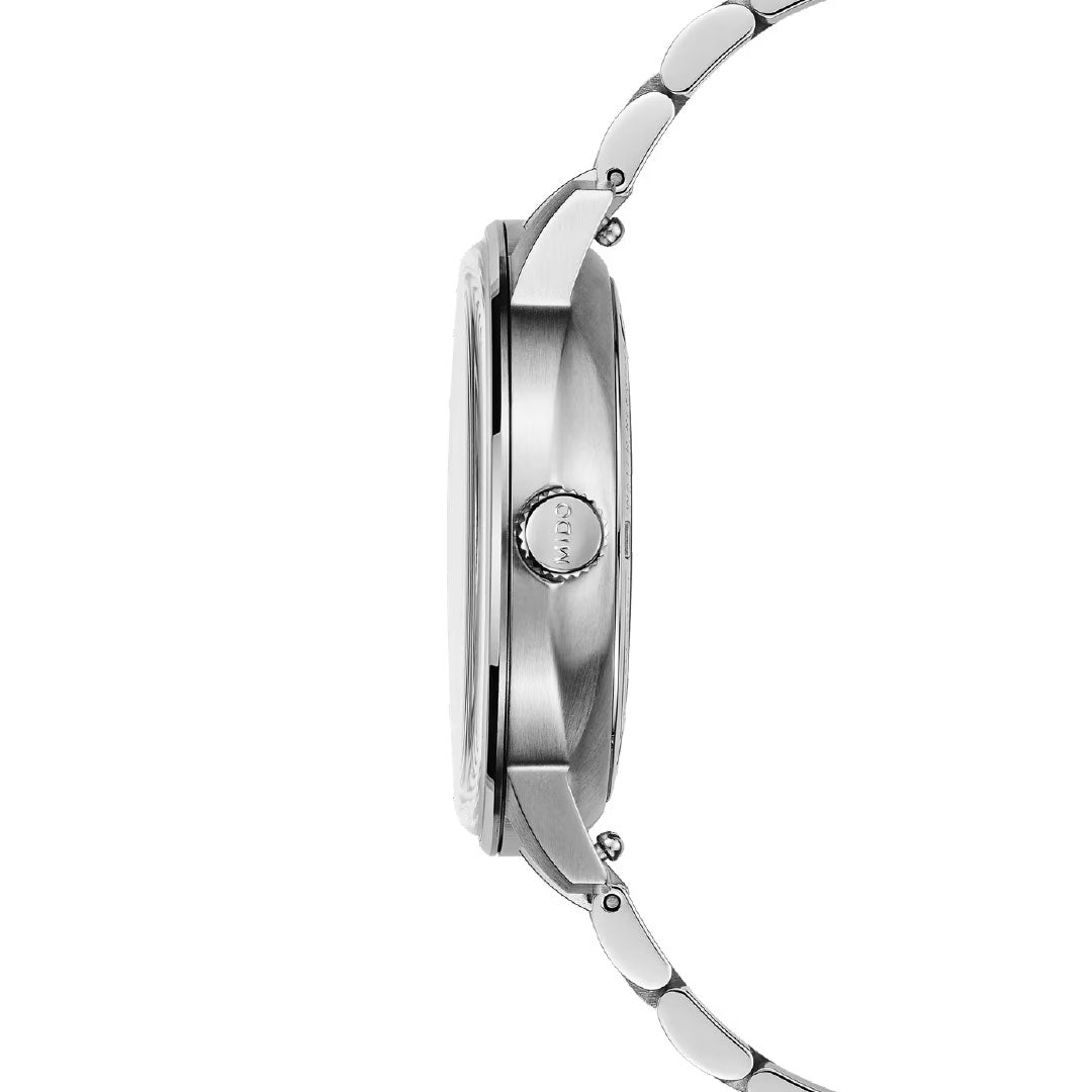 Side view of the slim MIDO Commander Datoday Automatic 40mm Watch, featuring a stainless-steel band and round crown, showcasing its thin profile, sleek design, and elegant day-date display.