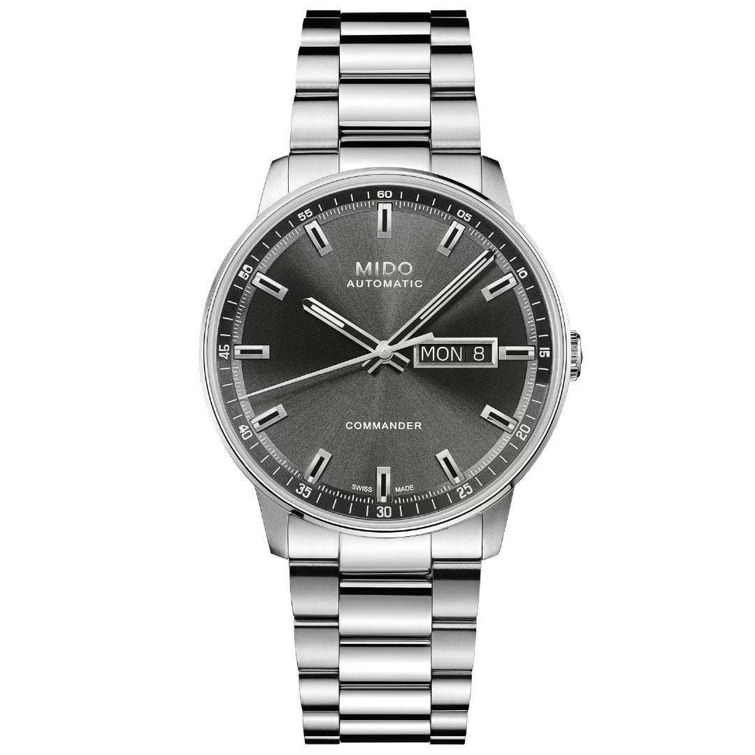 The MIDO Commander Datoday Automatic 40mm Watch features a stainless steel case, metallic bracelet, black gradient dial, silver hour markers, and a day-date window at 3 o’clock.