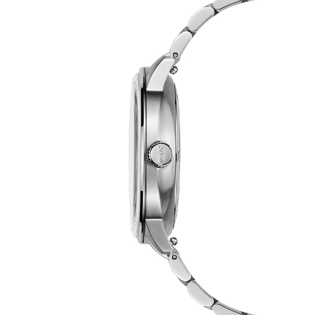 Side view of the MIDO Commander Datoday Automatic 40mm Watch, featuring a stainless steel case and band, slim profile, right-side round crown engraved with "MIDO," and an elegant day-date display.