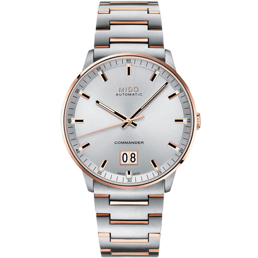 The MIDO Commander Big Date Automatic 42mm Watch features a silver dial, rose gold accents, a stainless steel bracelet, minimalist hour markers, Caliber 80 automatic movement, and a date window at 6 o’clock.