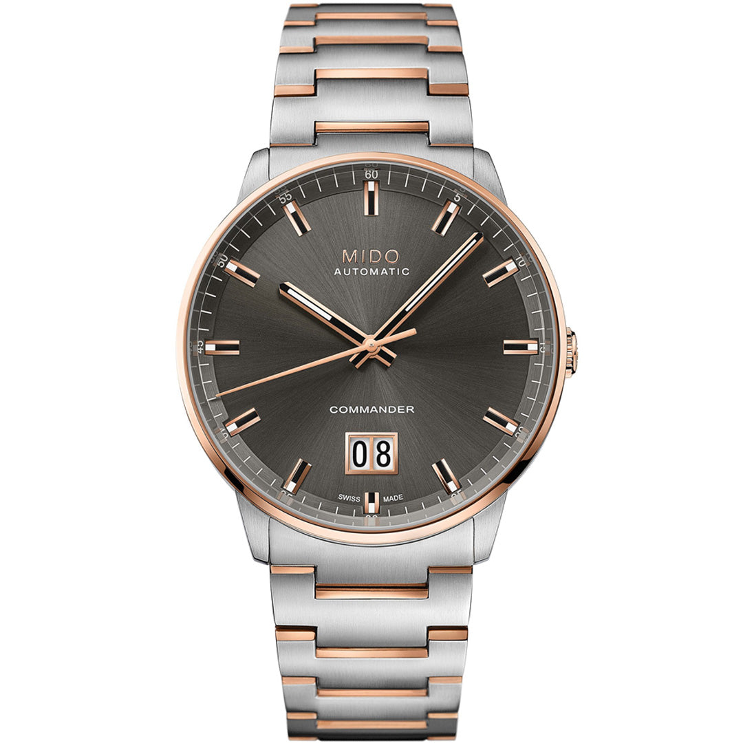 The MIDO Commander Big Date Automatic 42mm Watch features a silver and rose gold two-tone bracelet, dark gray sunburst dial, rose gold markers and hands, Caliber 80 movement, and a big date window at 6 o’clock.