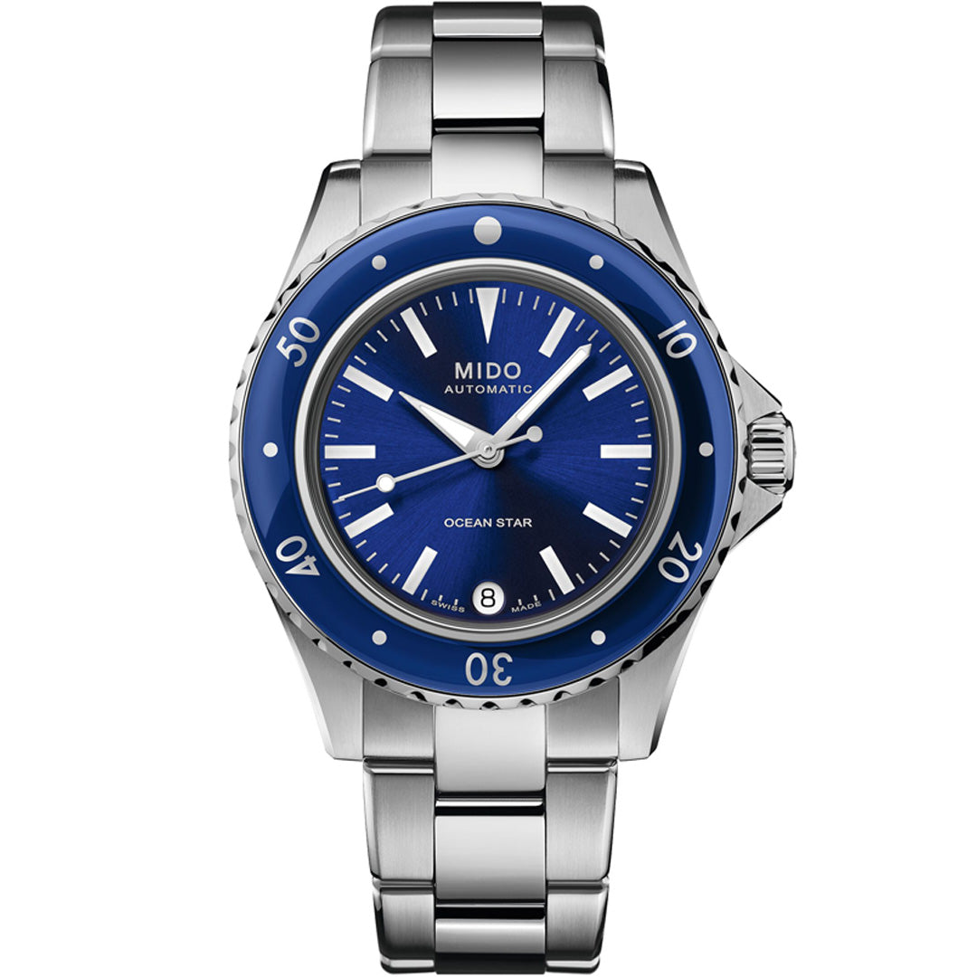 The MIDO Ocean Star 36.5 Automatic 36.5mm watch features a metallic blue bezel and dial, silver hour markers, a date window at 6 o’clock, water resistance, and a sleek stainless steel bracelet.
