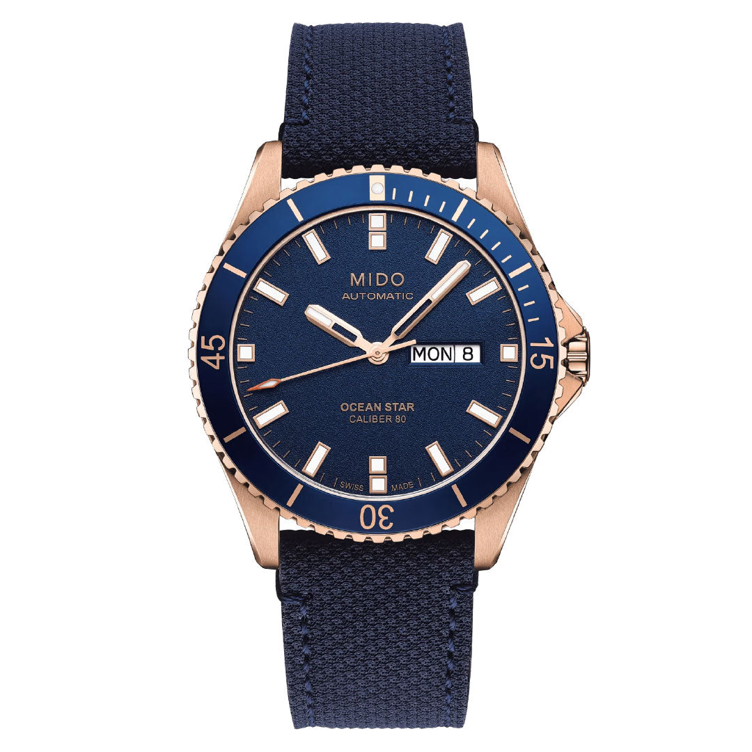 The MIDO Ocean Star 200 Automatic 42.5mm Watch features a blue dial, gold-tone case, blue bezel and fabric strap, with day/date displays, white markers and hands. Water resistant for daily use. Brand: MIDO.
