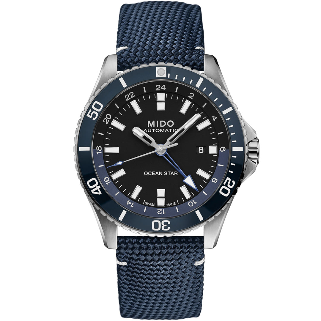 The MIDO Ocean Star GMT Automatic 44mm Watch features a black dial, blue rotating bezel, silver hour markers, date window at 3 o'clock, Caliber 80 movement, and a textured blue strap.