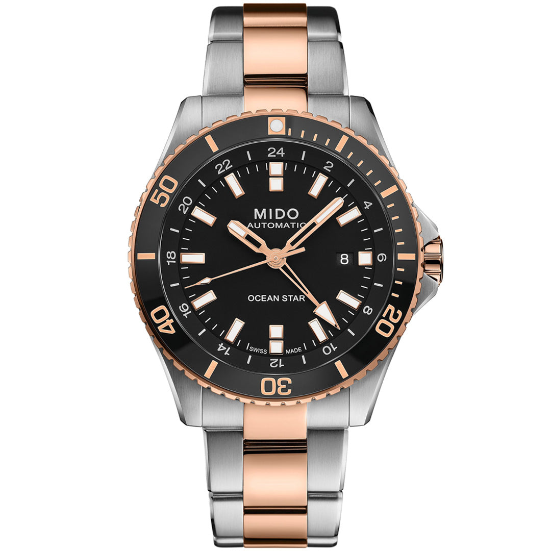 The MIDO Ocean Star GMT Automatic 44mm Watch features a black dial, silver and rose gold markers, date display, and two-tone bracelet. Powered by Caliber 80, it includes a black bezel with minute markings.