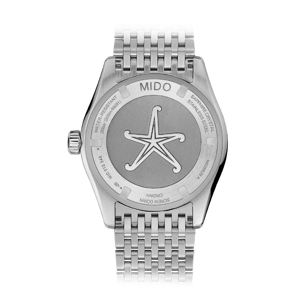 A MIDO Ocean Star Tribute GMT Automatic 40.5mm watch viewed from the back, featuring a starfish engraving and branded details on the stainless steel case back, with a metal link bracelet attached.