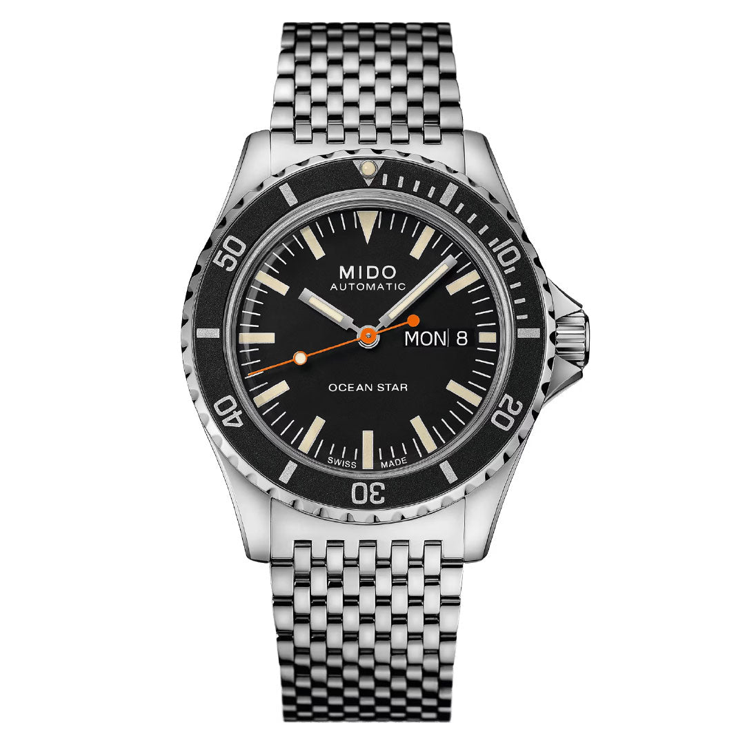 The MIDO Ocean Star Tribute Automatic 40.5mm Watch features a Caliber 80 automatic movement, black dial with silver hour markers, day-date display, minute-marked bezel, orange-accented hands, and a stainless steel link bracelet.
