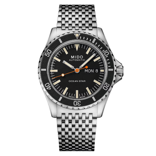 The MIDO Ocean Star Tribute Automatic 40.5mm Watch features a Caliber 80 automatic movement, black dial with silver hour markers, day-date display, minute-marked bezel, orange-accented hands, and a stainless steel link bracelet.