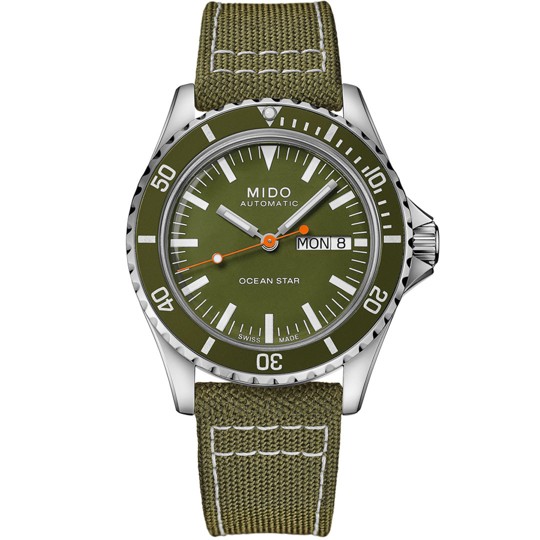 The MIDO Ocean Star Tribute Automatic 40.5mm Watch features an olive green dial, matching fabric strap, automatic movement, day/date display, white hour markers, orange-tipped hands, and a silver bezel with minute markings.