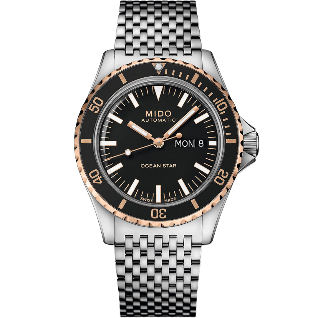 The MIDO Ocean Star Tribute Automatic 40.5mm watch by MIDO features a black dial, silver and rose gold bezel, silver markers, day-date window (Monday 8), and a silver metal link bracelet. The time displayed is 10:10.