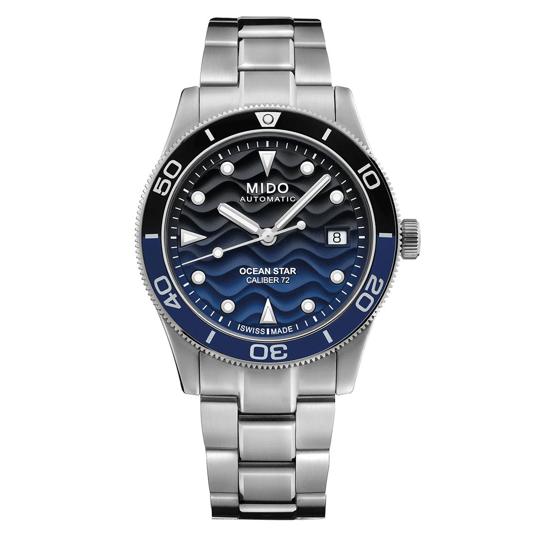 The MIDO Ocean Star 39mm Automatic Watch features a stainless steel case, blue wave-patterned dial with date at 3 o'clock, black and blue unidirectional bezel, metal bracelet, bold white markers, and water resistance.