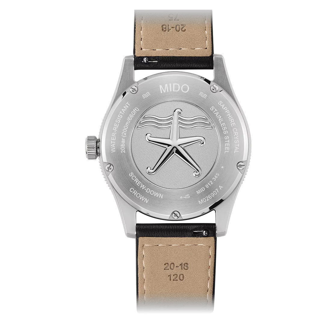 The back of the MIDO Ocean Star 39mm Automatic Watch, paired with a tan leather strap, showcases an embossed starfish design and engraved details, while its screw-down crown emphasizes the watch’s water-resistant capabilities and classic automatic engineering by MIDO.