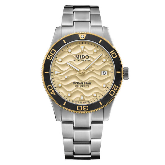 The MIDO Ocean Star 39mm Automatic Watch features a wavy gold-tone dial, black and gold bezel, date at 3 o’clock, stainless steel bracelet, Swiss-made quality, and water resistance for daily wear.