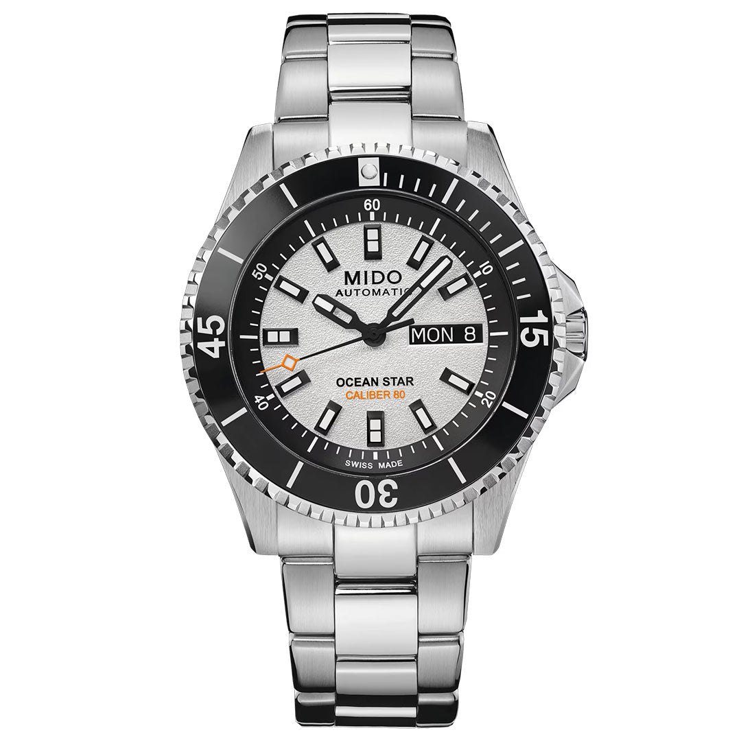 The MIDO Ocean Star 200 Automatic 41mm Watch by MIDO features a striking black bezel, a white textured dial with bold hour markers, and orange “Ocean Star Caliber 80” text on the face. Equipped with both day and date displays, this renowned performance timepiece from the Ocean Star 200 collection boasts a stainless steel band and water-resistant construction—making it ideal for everyday use or aquatic activities.