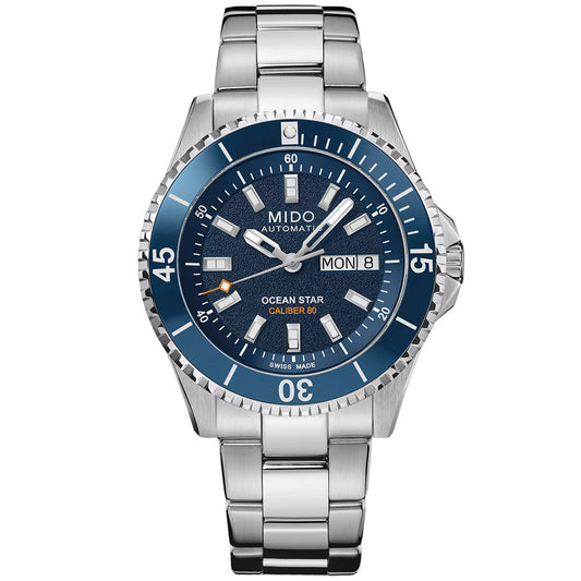 The MIDO Ocean Star 200 Automatic 41mm Watch features a blue dial, day-date display at 3 o’clock, silver hour markers, stainless steel link bracelet, and a blue water-resistant bezel with white numerals.