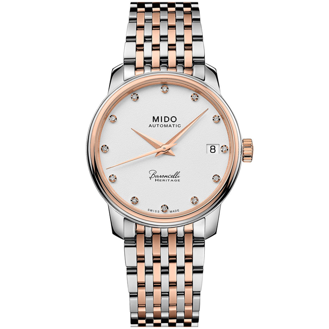 The MIDO Baroncelli III Heritage Lady Automatic 33mm Watch features a silver and rose gold two-tone metal band, white dial with diamond markers, date window at 3 o’clock, and slim hands.