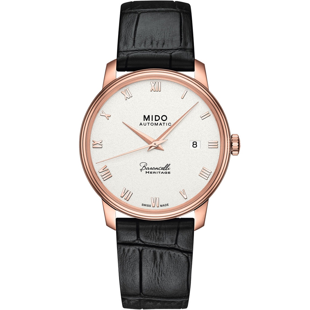The MIDO Baroncelli III Heritage Gent Automatic 39mm Watch features a white dial, rose gold case, Roman numerals, date at 3 o’clock, and a black leather strap—an elegant automatic timepiece from MIDO.