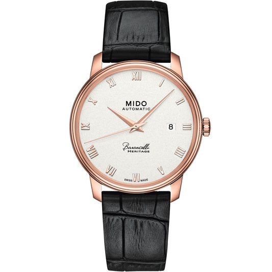 The MIDO Baroncelli III Heritage Gent Automatic 39mm Watch features a white dial, rose gold case, Roman numerals, date at 3 o’clock, and a black leather strap—an elegant automatic timepiece from MIDO.