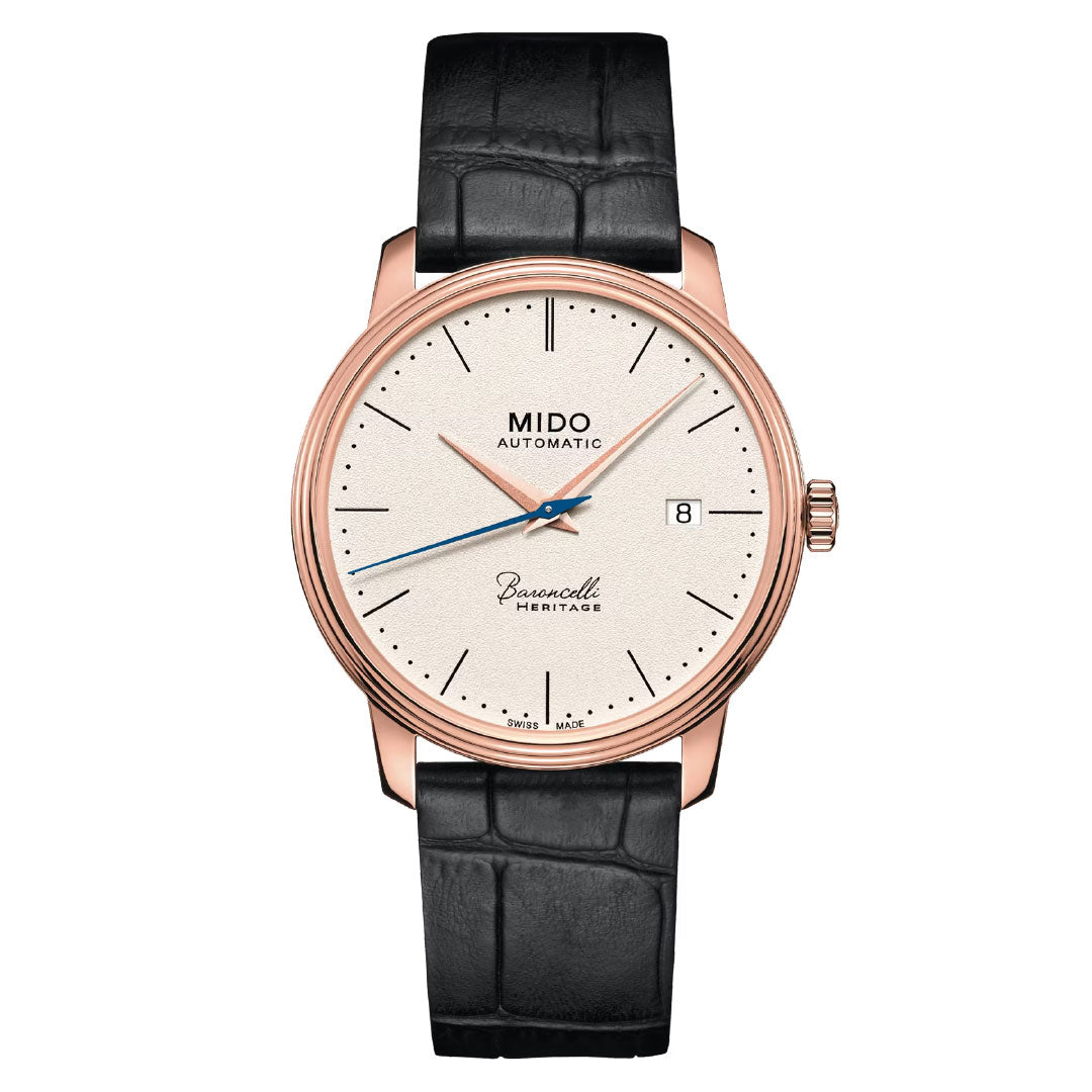 The MIDO Baroncelli III Heritage Gent Automatic 39mm Watch features a rose gold case, off-white dial, black leather strap, minimal hour markers, date at 3 o’clock, and blue second hand—classic elegance with modern automatic precision.