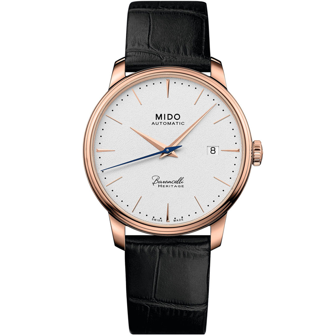 The MIDO Baroncelli Heritage Automatic 39mm watch features a white dial, gold case, black leather strap, slim gold markers and hands, date window at 3 o’clock, and “MIDO Automatic” on the face.