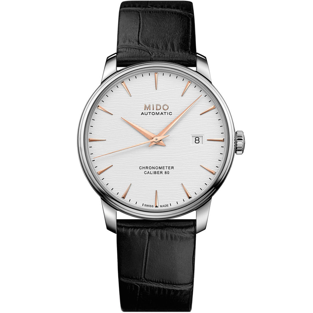 The MIDO Baroncelli III Chronometer Silicon Gent Automatic 40mm watch features a white dial, rose gold markers and hands, date at 3 o’clock, silver case, black leather strap, and a silicon balance-spring for greater precision.