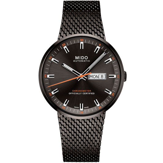The MIDO Commander Icône Automatic 42mm Watch features a black mesh strap, sunburst black dial, silver hour markers, orange accents, day-date window at 3 o’clock, and "CHRONOMETER OFFICIALLY CERTIFIED" on the face. COSC-certified chronometer.
