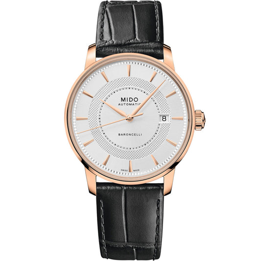 The MIDO Baroncelli II Signature Gent Automatic 39mm Watch features a white dial, gold case, black leather strap, gold hour markers, date at 3 o’clock, “MIDO AUTOMATIC BARONCELLI” on the face, and a precise Nivachron balance spring.