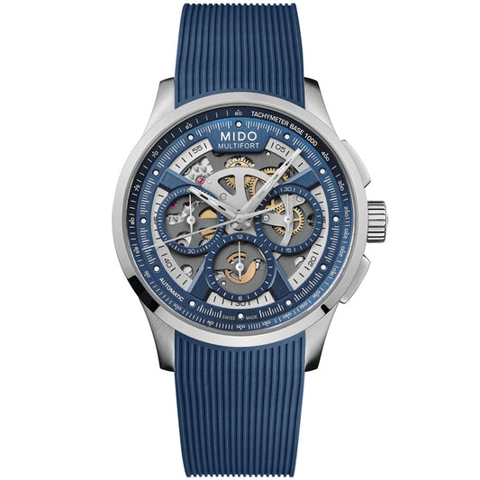 The MIDO Multifort Skeleton Chronograph Automatic 43mm Watch features a silver case, blue skeleton dial with visible gears, chronograph subdials, tachymeter scale, Swiss automatic movement, and a blue textured rubber strap.