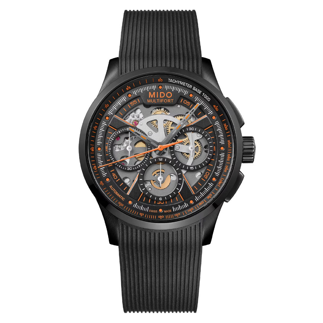 The MIDO Multifort Skeleton Chronograph Automatic 43mm Watch features a black case, skeleton dial with visible gears, orange accents, multiple subdials, tachymeter bezel markings, and a black ribbed strap.
