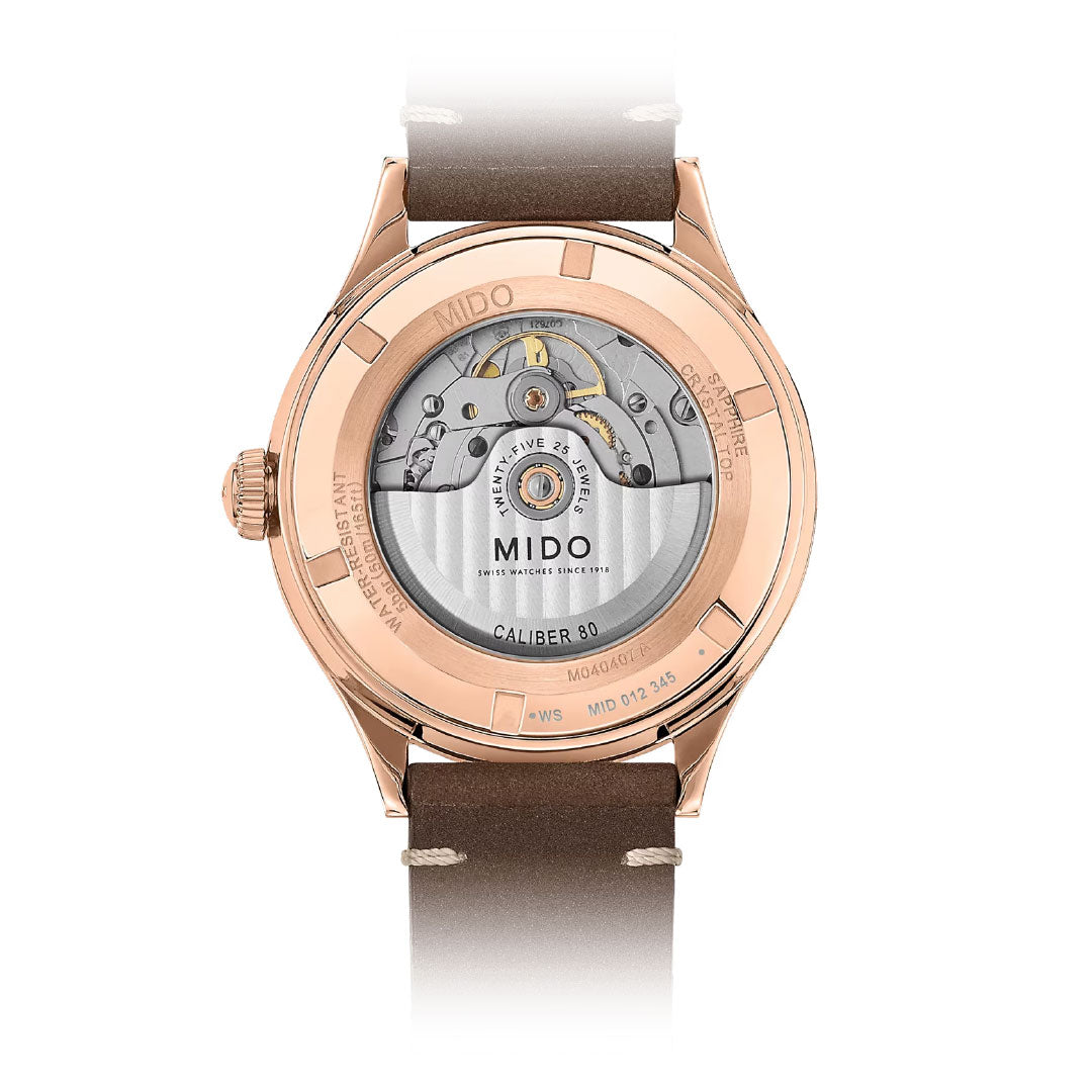 Back view of the MIDO Multifort Patrimony Automatic 40mm Watch, featuring a brown leather strap, rose gold case, and transparent case back that showcases the Caliber 80 automatic movement with engraved details.