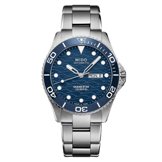 The MIDO Ocean Star 200C Automatic 42.5mm Watch features a blue wave-patterned dial with luminous markers, day/date at 3 o'clock, stainless steel bracelet, and automatic movement.