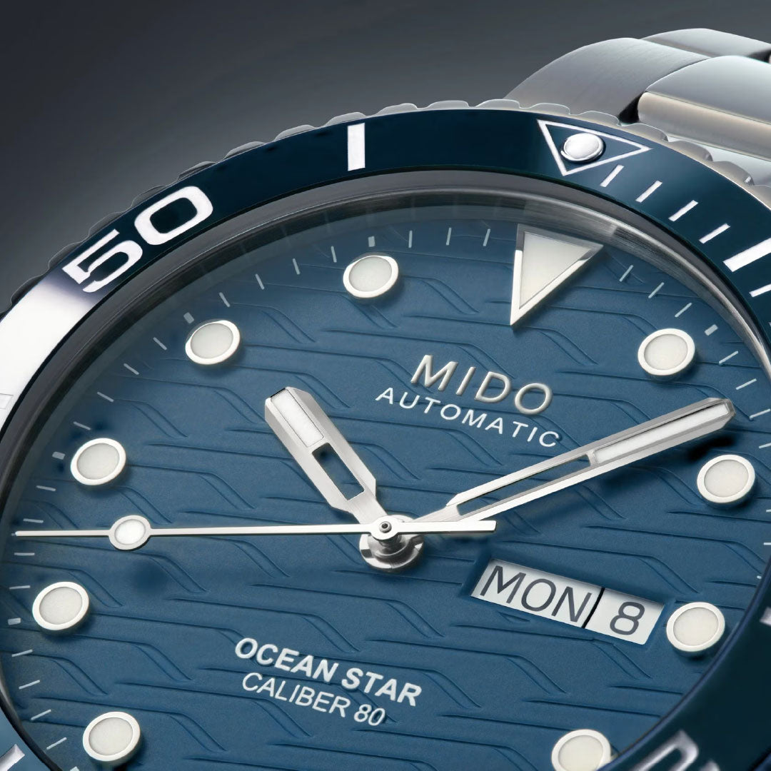 Close-up of the MIDO Ocean Star 200C Automatic 42.5mm Watch, featuring a textured blue dial, silver markers and hands, ceramic bezel, day-date display, and a stainless steel bracelet.