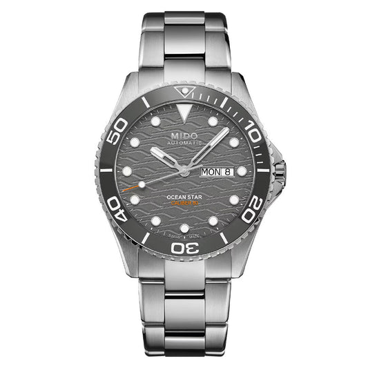 The MIDO Ocean Star 200C Automatic 42.5mm Watch features a silver metal bracelet, ceramic bezel, grey wave-patterned dial, bold white hour markers, automatic movement, and a day-date display at 3 o'clock.