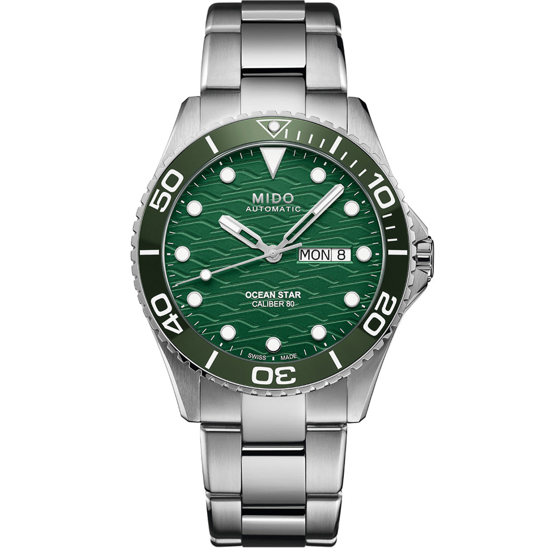 The MIDO Ocean Star 200C Automatic 42.5mm Watch features a silver stainless steel case, green ceramic bezel, green textured dial, round hour markers, and a day-date display at 3 o’clock.
