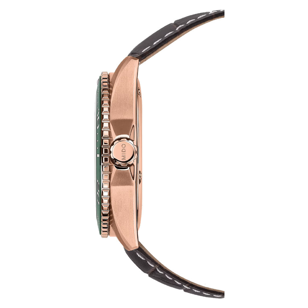 Side view of the MIDO Ocean Star 200C Automatic 42.5mm watch in rose gold, featuring a black leather strap, knurled ceramic bezel, and an engraved “MIDO” crown. The elegant case highlights its minimalist design.