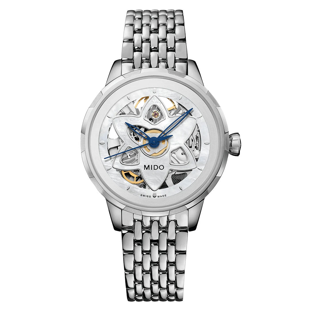 The MIDO Rainflower Blossom Automatic 34mm watch features a skeleton dial with silver and white tones, blue and gold-accented hands and mechanisms, visible intricate gears, and a metal link band.
