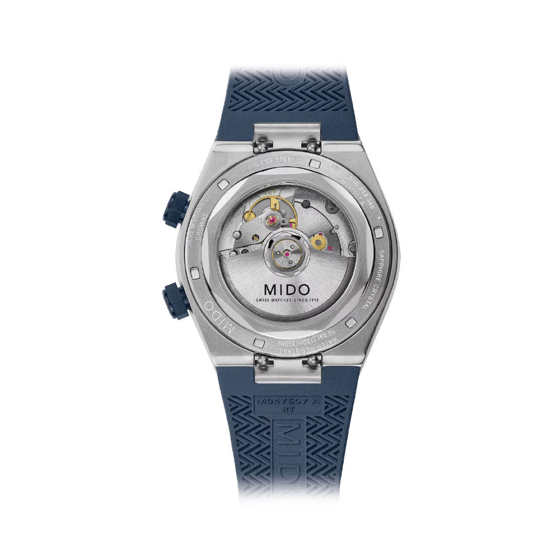 The back of the MIDO Multifort 8 Two Crowns Automatic 40mm Watch reveals its intricate Calibre 72 movement through a transparent case, paired with a navy blue textured rubber strap.