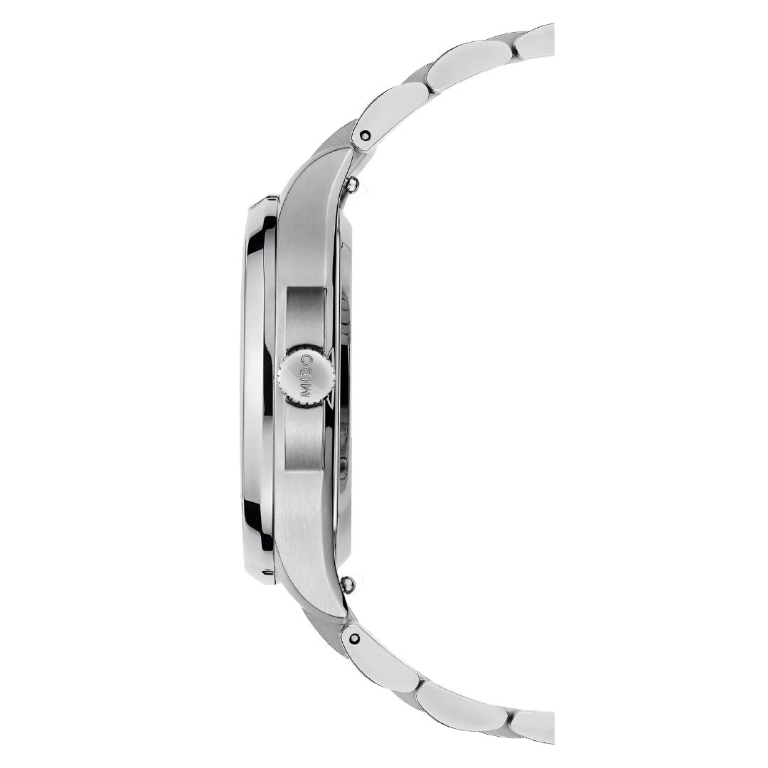 Side view of the MIDO Multifort TV 35 Automatic 35mm Watch in silver, featuring a metal link band and a brushed metallic case with an engraved, gear-edged crown. The watch face is not visible.