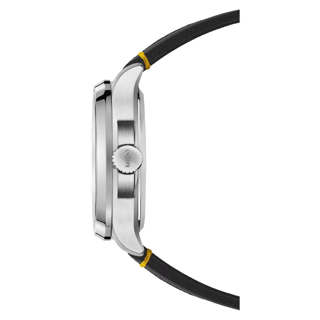 Side view of the MIDO Multifort TV Big Date Automatic 40mm Watch featuring a silver case, ridged crown with "MIDO," and black strap with yellow stitching at the lugs; highlights its precise automatic movement.