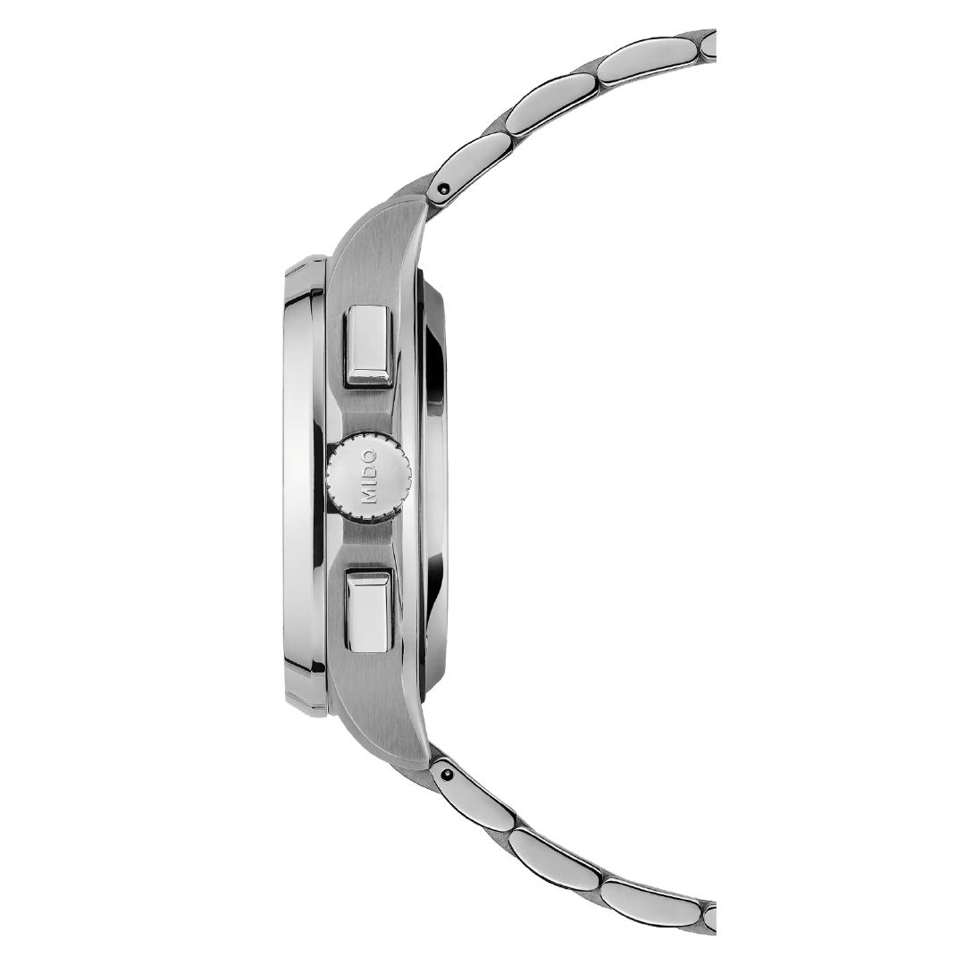 A side view of the MIDO Multifort TV Chronograph Automatic 42mm Watch shows its silver linked band, two buttons, and a crown on the case, emphasizing the watch’s polished finish and thickness.