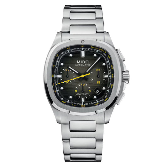 The MIDO Multifort TV Chronograph Automatic 42mm features a stainless steel band, black textured dial with yellow accents, chronograph subdials, date at 4 o’clock, and a distinctive TV-shaped case for a modern sporty look.